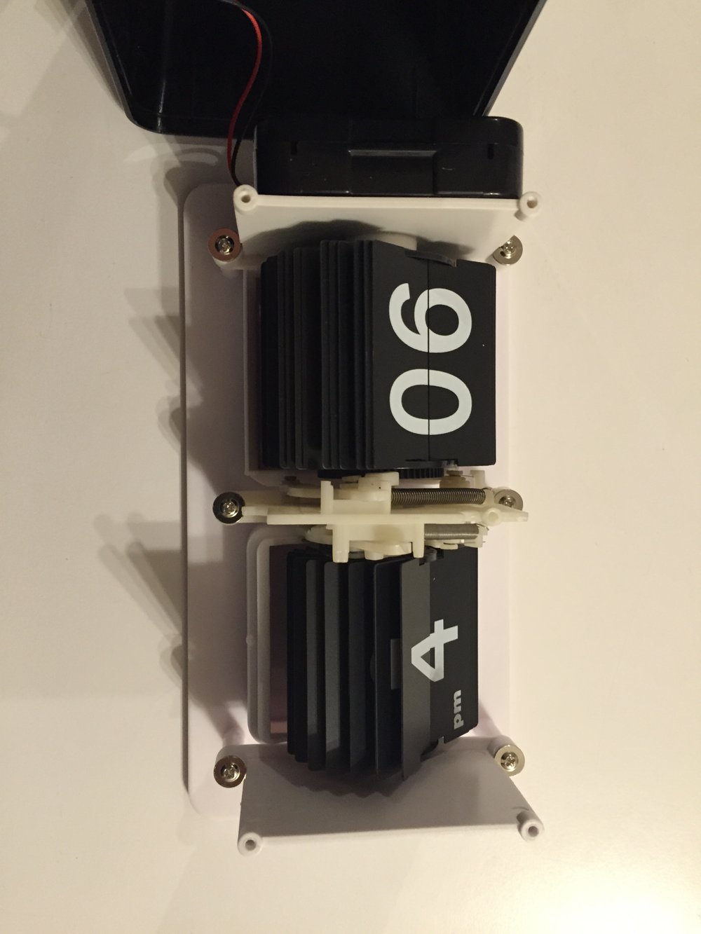  One of the interesting parts are the two small levers that let you move the wheel (change the time) separately of each other. But if you make the minute wheel go from 59 -> 0 the hour wheel will cycle to the next number. The implication of this i